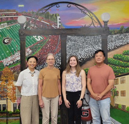 Emily Walter and the members of her M.S. graduate committee stand in front of the mural at NESPAL South at UGA-Tifton. Left to right: Dr. Ye Chu, Dr. Peggy Ozias-Akins, Emily Walter, and Dr. Peng Chee.